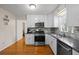 Functional kitchen with stainless steel appliances, modern backsplash, and updated countertops at 1417 Hickory Sw Dr, Lilburn, GA 30047