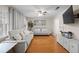 Inviting living room with wood floors, neutral decor, and ample natural light from large windows at 1417 Hickory Sw Dr, Lilburn, GA 30047