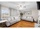 Bright and airy living room with hardwood floors, two sofas, and walls adorned with decorative photos at 1417 Hickory Sw Dr, Lilburn, GA 30047