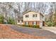 Two-story home highlighting its back with a driveway and backyard access at 1417 Hickory Sw Dr, Lilburn, GA 30047