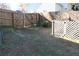 Large, grassy, fenced backyard with landscaping and shade at 2335 Corbett Ct, Powder Springs, GA 30127