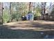 Spacious, grassy backyard features a storage shed and wooded perimeter at 2335 Corbett Ct, Powder Springs, GA 30127