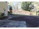 Large backyard with stone patio, garden bed, and wood privacy fences at 2335 Corbett Ct, Powder Springs, GA 30127