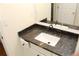 Bathroom vanity with a dark granite countertop and white sink at 2335 Corbett Ct, Powder Springs, GA 30127