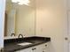Neutral bathroom featuring a vanity with a black marble top, large mirror, and white cabinets at 2335 Corbett Ct, Powder Springs, GA 30127