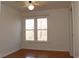 Bedroom with hardwood floors, ceiling fan, and a double window overlooking trees at 2335 Corbett Ct, Powder Springs, GA 30127