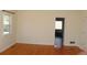 Spacious bedroom with hardwood floors leading to an ensuite bath at 2335 Corbett Ct, Powder Springs, GA 30127