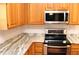 Kitchen with granite countertops, stainless steel appliances, and light wood cabinets at 2335 Corbett Ct, Powder Springs, GA 30127