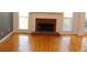Bright living room boasts a brick fireplace and beautiful hardwood floors at 2335 Corbett Ct, Powder Springs, GA 30127