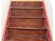 Close-up of wooden stairs with textured surface and red edging, showcasing the details at 2335 Corbett Ct, Powder Springs, GA 30127