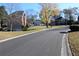 Street view with well-maintained homes, landscaping, and mature trees in a quiet neighborhood at 2335 Corbett Ct, Powder Springs, GA 30127