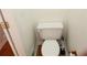 Toilet in the bathroom with white tile and wood flooring at 2335 Corbett Ct, Powder Springs, GA 30127