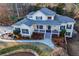 Aerial view of a charming yellow home with green shutters, mature trees and a manicured lawn at 7364 N Mitchell N Ct, Villa Rica, GA 30180