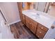 Bathroom featuring a vanity with lots of storage cabinets, white countertop and dark wood-look floor at 7364 N Mitchell N Ct, Villa Rica, GA 30180