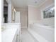 Bathroom featuring a large tub, separate shower, and a vanity with a sink, all in a bright and clean space at 7364 N Mitchell N Ct, Villa Rica, GA 30180