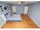 Bedroom featuring hardwood floors, large windows, and light-blue painted walls for a cozy and spacious feel at 7364 N Mitchell N Ct, Villa Rica, GA 30180