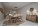 Bright dining room featuring a wood table and chairs, wooden sideboard, and neutral decor at 7364 N Mitchell N Ct, Villa Rica, GA 30180