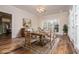 Bright dining room with elegant table set, complemented by natural light and views of adjacent kitchen at 7364 N Mitchell N Ct, Villa Rica, GA 30180