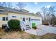Charming home with a well-manicured lawn, stairs to the front door, and a two-car garage at 7364 N Mitchell N Ct, Villa Rica, GA 30180