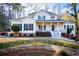 Charming yellow two-story home with green shutters and inviting front porch at 7364 N Mitchell N Ct, Villa Rica, GA 30180