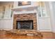 Elegant stone fireplace with custom mantle, flanked by white built-in cabinets for stylish storage at 7364 N Mitchell N Ct, Villa Rica, GA 30180