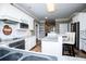 Bright kitchen with white cabinetry, granite countertops, stainless appliances, and a bar-height breakfast bar at 7364 N Mitchell N Ct, Villa Rica, GA 30180