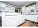 Open kitchen with white cabinets, granite counters, stainless steel appliances, and a view to a breakfast bar at 7364 N Mitchell N Ct, Villa Rica, GA 30180