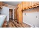 Well-equipped laundry room featuring wood cabinets, wood-look floors and convenient washer/dryer hookups at 7364 N Mitchell N Ct, Villa Rica, GA 30180