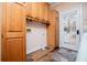 Functional laundry room with wooden cabinets and a door to the outside at 7364 N Mitchell N Ct, Villa Rica, GA 30180