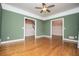 Spacious living room features hardwood floors, crown molding, and ample natural light through large windows at 7364 N Mitchell N Ct, Villa Rica, GA 30180
