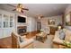 Cozy living room boasts a stone fireplace, custom built-ins, and neutral decor for a relaxing ambiance at 7364 N Mitchell N Ct, Villa Rica, GA 30180