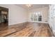 Large, versatile area with light walls and wood floors, with view into kitchen at 7364 N Mitchell N Ct, Villa Rica, GA 30180