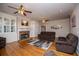 Open living room featuring hardwood floors, fireplace, built-in shelving and comfortable seating at 7364 N Mitchell N Ct, Villa Rica, GA 30180