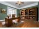 Inviting office with wood desk, built-in bookcase, and bright window for an ideal work-from-home space at 7364 N Mitchell N Ct, Villa Rica, GA 30180