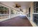 Wide covered patio with ceiling fans offering a perfect space for enjoying the outdoors and entertaining guests at 7364 N Mitchell N Ct, Villa Rica, GA 30180