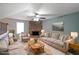 Cozy living room with stone fireplace, neutral furniture, and plenty of natural light at 1946 Taffeta Trl, Lithonia, GA 30058