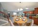 Bright, open-concept living and dining area features modern decor and staircase at 1946 Taffeta Trl, Lithonia, GA 30058