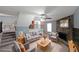 Inviting living room with stone fireplace, stairs, and comfortable seating arrangement at 1946 Taffeta Trl, Lithonia, GA 30058