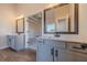 Bathroom featuring dual vanities with light gray cabinetry, white countertops, and modern fixtures at 215 Pinewood Dr, Covington, GA 30014