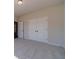 A bedroom with neutral paint, carpet, and double-door closet for ample storage at 215 Pinewood Dr, Covington, GA 30014