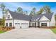 Stunning home featuring a white exterior, black shutters, and a spacious three-car garage at 215 Pinewood Dr, Covington, GA 30014