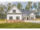 Charming white home with black shutters, a gabled roof, and a lush green lawn at 215 Pinewood Dr, Covington, GA 30014