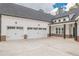 Spacious three-car garage featuring white doors and black hardware with convenient access to the home at 215 Pinewood Dr, Covington, GA 30014