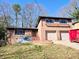 Two-story brick home featuring a 2-car garage and a well-maintained front yard, showcasing classic curb appeal at 2348 Jones Nw Rd, Atlanta, GA 30318