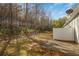 Backyard view of home featuring patio and partial fence, with trees visible beyond at 2411 Heritage Park Nw Cir # 14, Kennesaw, GA 30144