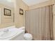 Neutral-toned bathroom featuring a vanity and shower with a patterned curtain at 2411 Heritage Park Nw Cir # 14, Kennesaw, GA 30144