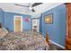 Spacious bedroom featuring a large bed, fan and private access to the ensuite bathroom at 2411 Heritage Park Nw Cir # 14, Kennesaw, GA 30144
