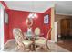 View of a dining room with a round glass table, ornate chairs, and red walls at 2411 Heritage Park Nw Cir # 14, Kennesaw, GA 30144