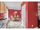 View of a dining room with a round glass table, ornate chairs, and red walls at 2411 Heritage Park Nw Cir # 14, Kennesaw, GA 30144