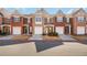 Charming townhome exterior with brick facade, attached garage, and well-maintained landscaping at 2411 Heritage Park Nw Cir # 14, Kennesaw, GA 30144